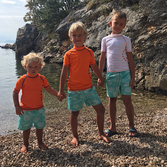 Turquoise turtle print board shorts